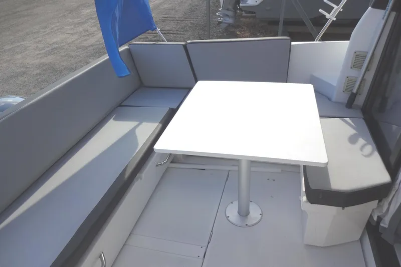 Blue Baby Yacht Photos Pics 2022 Jeanneau Merry Fisher 895 Offshore boat interior with seating and table.