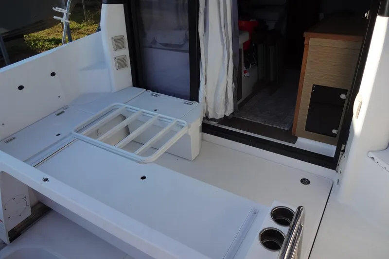 Blue Baby Yacht Photos Pics 2022 Jeanneau Merry Fisher 895 Offshore boat interior with seating and storage.