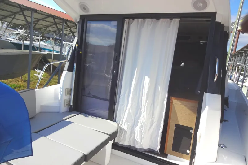 Blue Baby Yacht Photos Pics 2022 Jeanneau Merry Fisher 895 Offshore boat interior with sliding door and seating area.