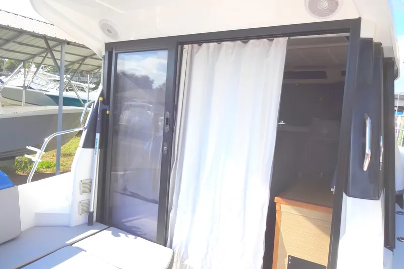 Blue Baby Yacht Photos Pics Sliding door and curtain on 2022 Jeanneau Merry Fisher 895 Offshore boat.
