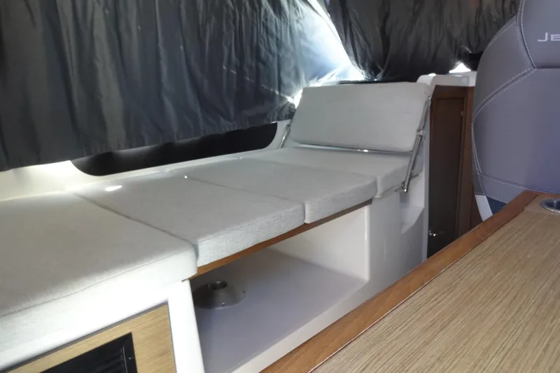 Blue Baby Yacht Photos Pics Interior of 2022 Jeanneau Merry Fisher 895 Offshore, featuring cushioned seating and wooden accents.