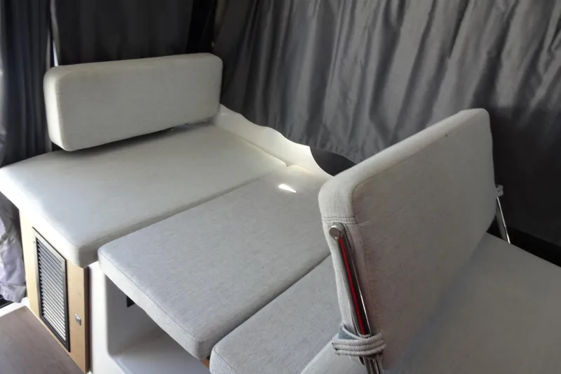 Blue Baby Yacht Photos Pics Interior seating of 2022 Jeanneau Merry Fisher 895 Offshore boat, featuring gray cushions.
