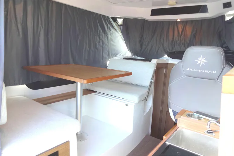 Blue Baby Yacht Photos Pics Interior of 2022 Jeanneau Merry Fisher 895 Offshore, featuring seating and dining area.