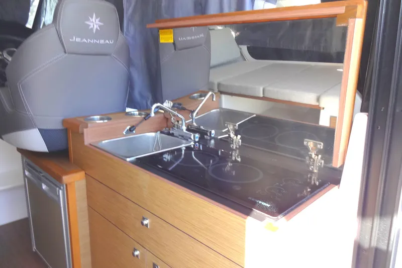 Blue Baby Yacht Photos Pics 2022 Jeanneau Merry Fisher 895 Offshore interior kitchen with sink and stove.