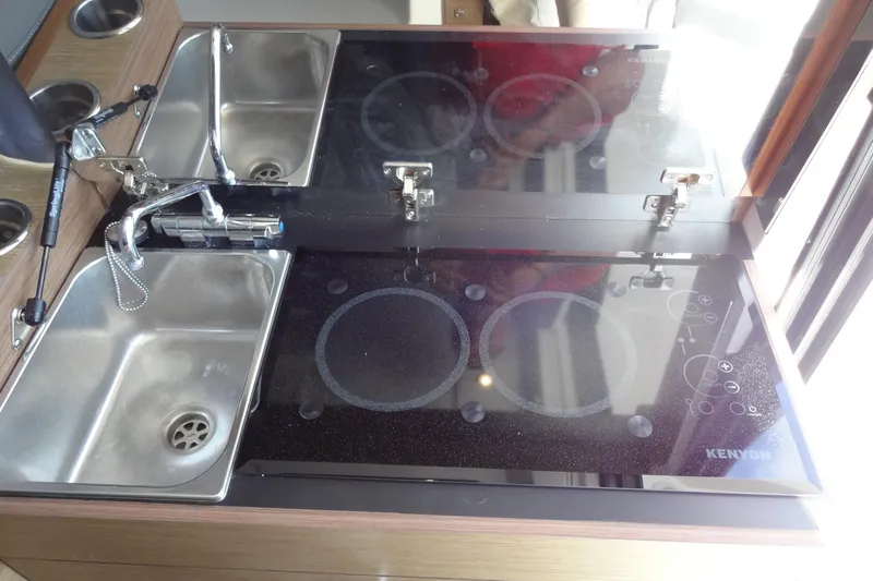 Blue Baby Yacht Photos Pics Modern kitchen area in 2022 Jeanneau Merry Fisher 895 Offshore boat with sink and Kenyon cooktop.