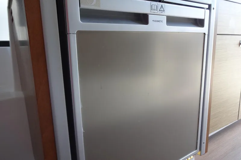 Blue Baby Yacht Photos Pics Compact Dometic fridge inside 2022 Jeanneau Merry Fisher 895 Offshore boat cabin.