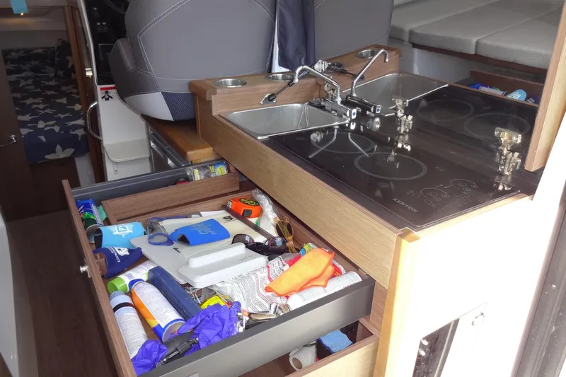 Blue Baby Yacht Photos Pics Interior of 2022 Jeanneau Merry Fisher 895 Offshore with kitchen and storage drawer.