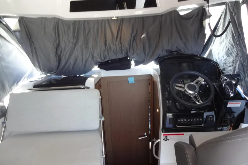 Blue Baby Yacht Photos Pics Interior of 2022 Jeanneau Merry Fisher 895 Offshore boat, featuring helm and seating area.