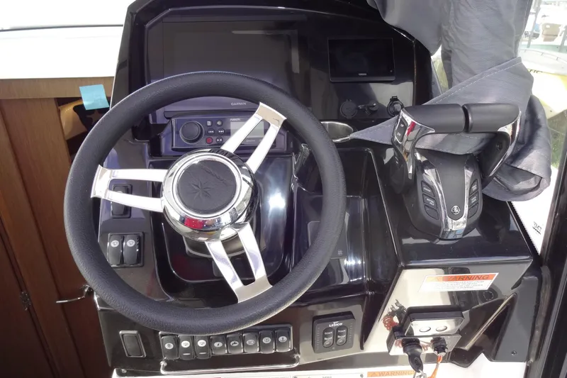 Blue Baby Yacht Photos Pics Steering console of 2022 Jeanneau Merry Fisher 895 Offshore boat with controls and display.