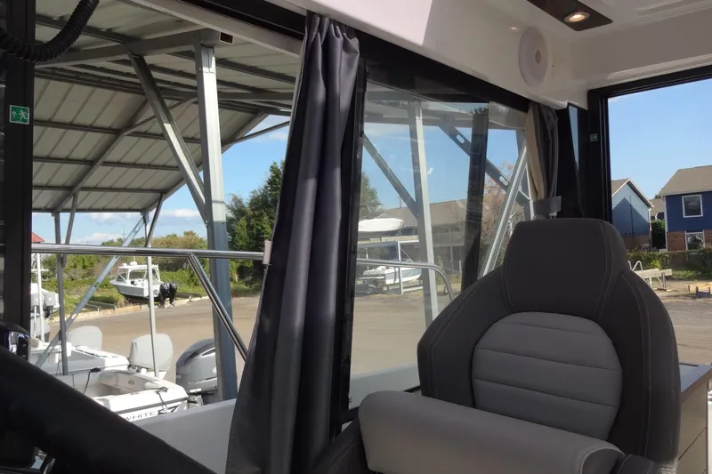 Blue Baby Yacht Photos Pics Interior view of 2022 Jeanneau Merry Fisher 895 Offshore boat with dockside background.