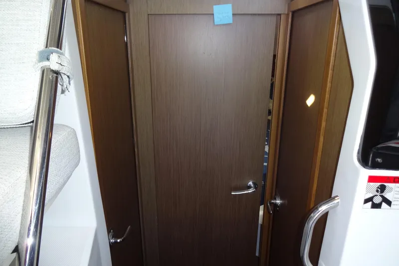 Blue Baby Yacht Photos Pics Interior view of 2022 Jeanneau Merry Fisher 895 Offshore, featuring wooden doors and modern design.