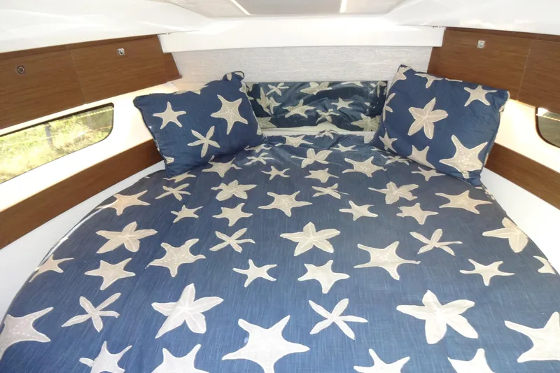 Blue Baby Yacht Photos Pics Cabin interior of 2022 Jeanneau Merry Fisher 895 Offshore with starfish bedding.