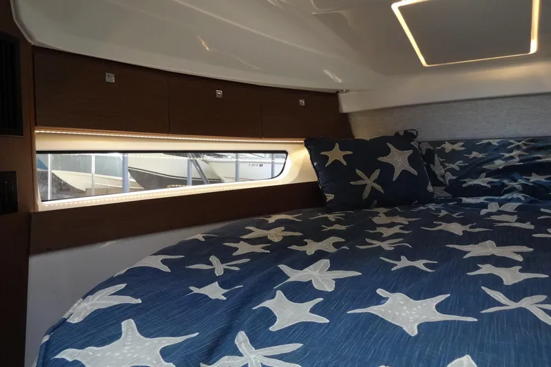 Blue Baby Yacht Photos Pics Cozy cabin interior of 2022 Jeanneau Merry Fisher 895 Offshore with starfish bedding.