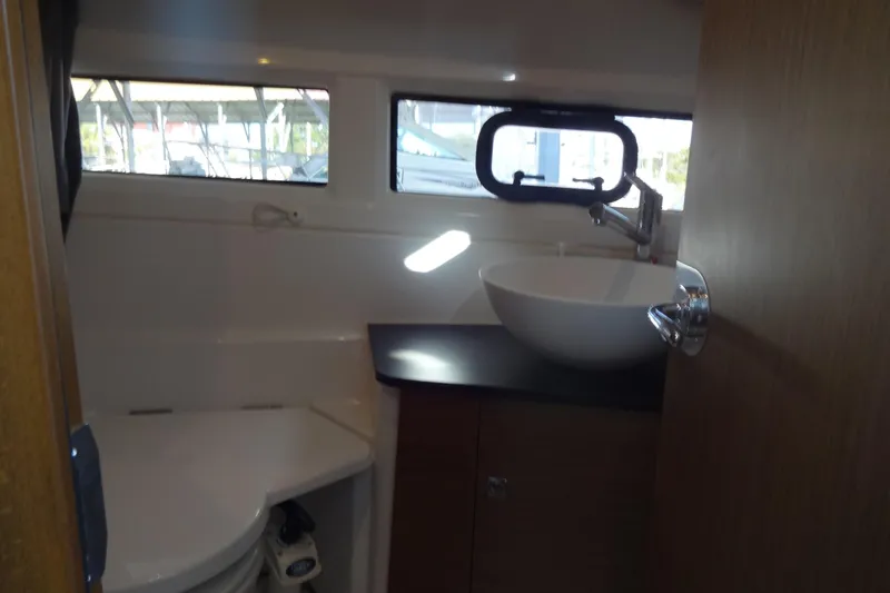Blue Baby Yacht Photos Pics Interior of 2022 Jeanneau Merry Fisher 895 Offshore bathroom with sink and window.