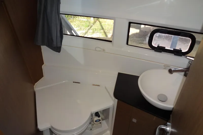 Blue Baby Yacht Photos Pics 2022 Jeanneau Merry Fisher 895 Offshore bathroom with sink, toilet, and window.