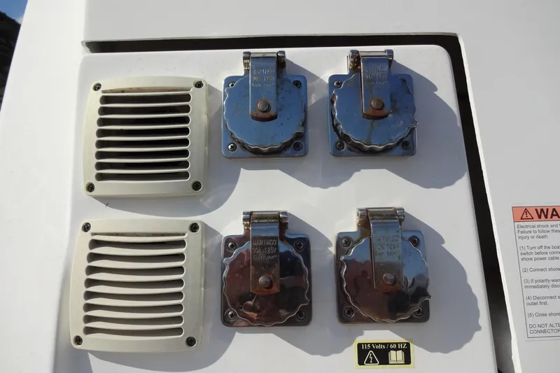 Blue Baby Yacht Photos Pics Electrical panel on 2022 Jeanneau Merry Fisher 895 Offshore boat with warning label.