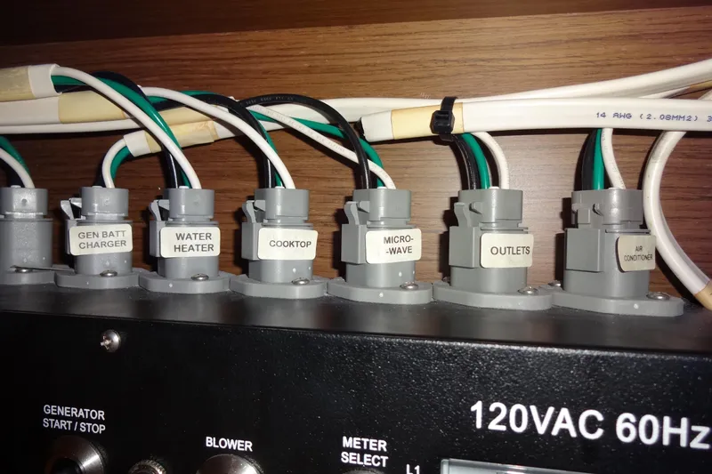 Blue Baby Yacht Photos Pics Electrical panel of 2022 Jeanneau Merry Fisher 895 Offshore boat, labeled switches and wiring.