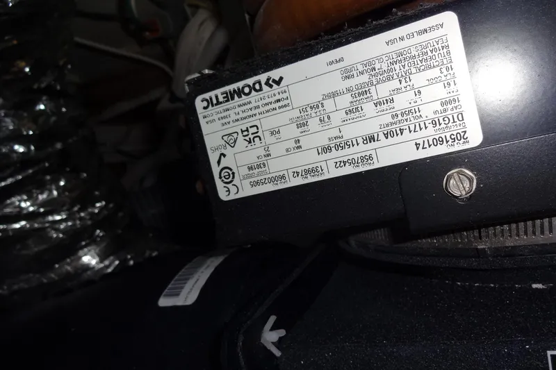 Blue Baby Yacht Photos Pics Close-up of a Dometic component label inside a 2022 Jeanneau Merry Fisher 895 Offshore.