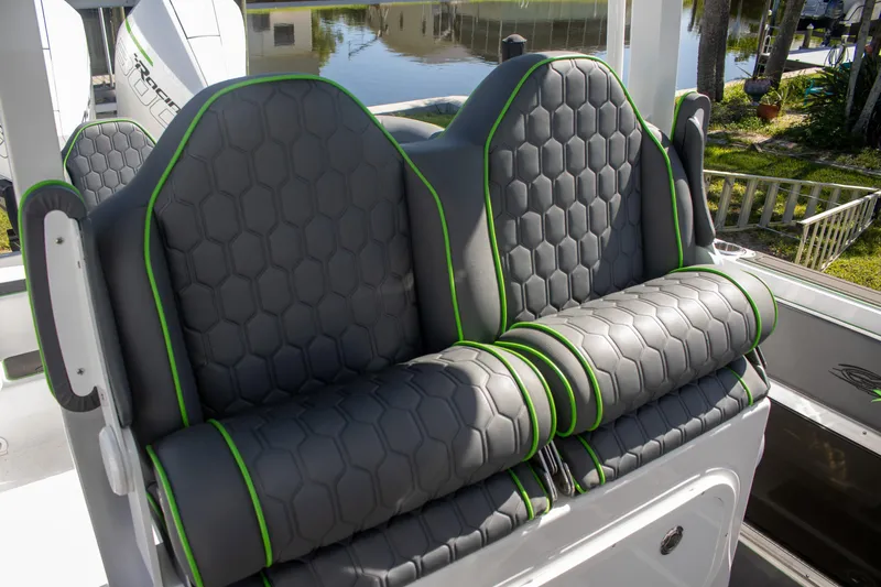 Adeline Yacht Photos Pics 2023 Glasstream 328 GS Xtreme boat seats with hexagonal pattern and green accents.