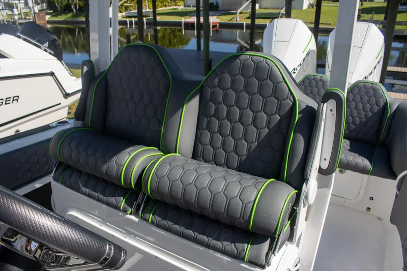 Adeline Yacht Photos Pics 2023 Glasstream 328 GS Xtreme boat seats with hexagonal pattern and green accents.
