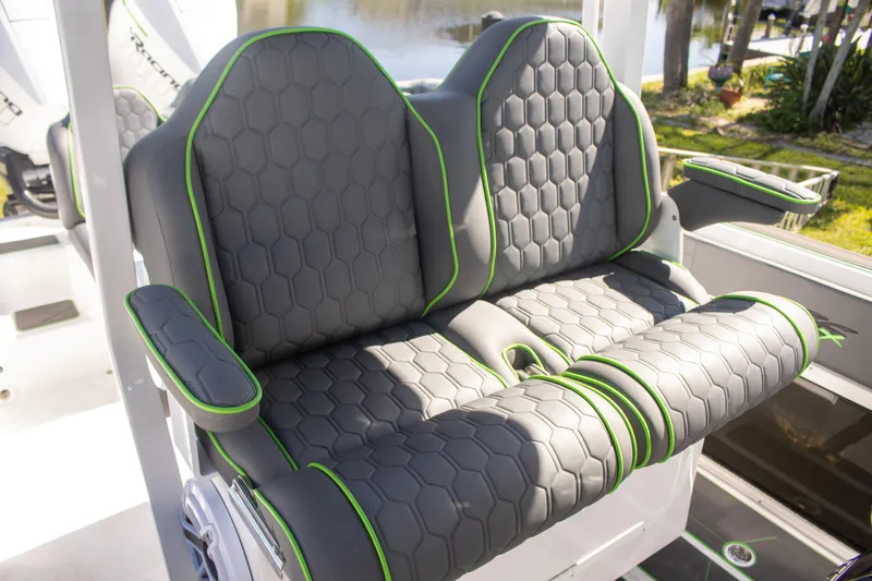 Adeline Yacht Photos Pics 2023 Glasstream 328 GS Xtreme boat seats with hexagonal pattern and green accents.