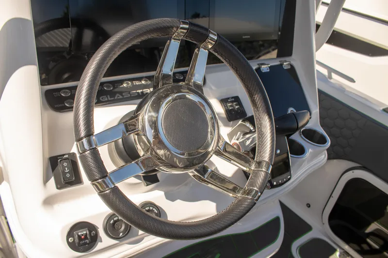 Adeline Yacht Photos Pics Steering wheel of 2023 Glasstream 328 GS Xtreme boat, featuring modern controls and dashboard.