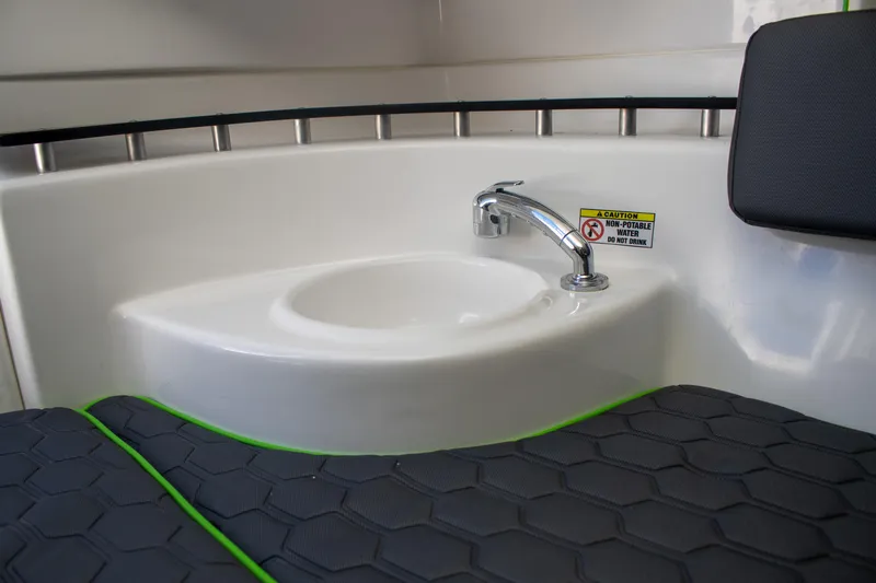 Adeline Yacht Photos Pics 2023 Glasstream 328 GS Xtreme interior with sink and cushioned seating.