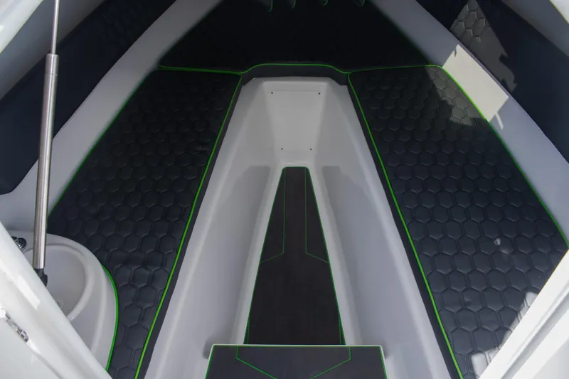 Adeline Yacht Photos Pics 2023 Glasstream 328 GS Xtreme interior with hexagonal pattern flooring and green accents.