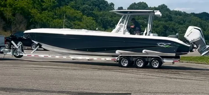 Adeline Yacht Photos Pics 2023 Glasstream 328 GS Xtreme boat on trailer, parked outdoors.