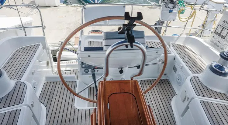 Pelican Yacht Photos Pics Cockpit of 2002 Jeanneau Sun Odyssey 43 DS sailboat with wooden wheel and seating.