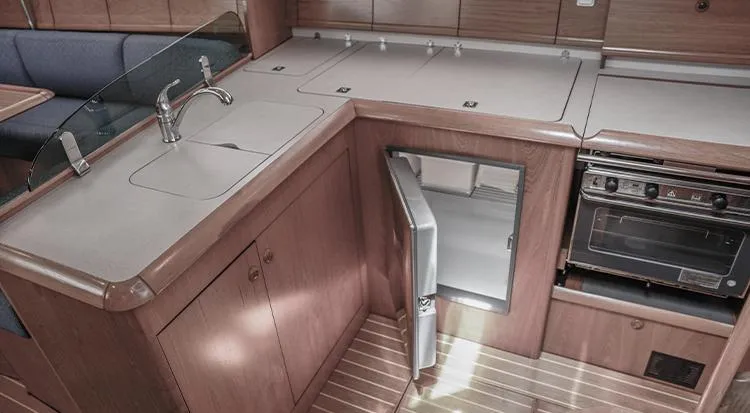 Pelican Yacht Photos Pics Interior of 2002 Jeanneau Sun Odyssey 43 DS yacht kitchen with sink, fridge, and oven.