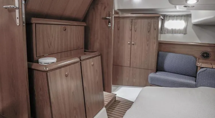 Pelican Yacht Photos Pics Interior of 2002 Jeanneau Sun Odyssey 43 DS yacht with wooden cabinetry and cozy seating.