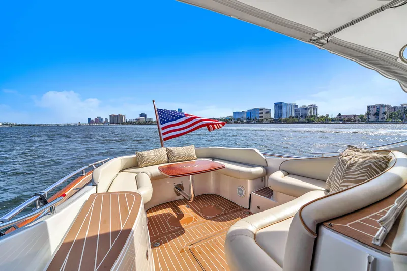 Mississippi Queen Yacht Photos Pics Luxurious 2012 Zeelander 44 yacht with American flag, cruising near city skyline.