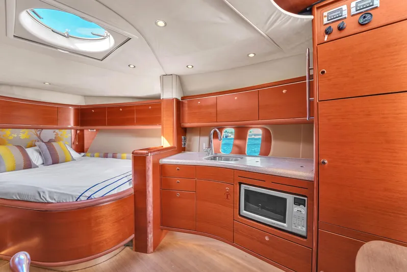 Mississippi Queen Yacht Photos Pics Luxurious interior of 2012 Zeelander 44 yacht with wood finish, bed, and kitchenette.