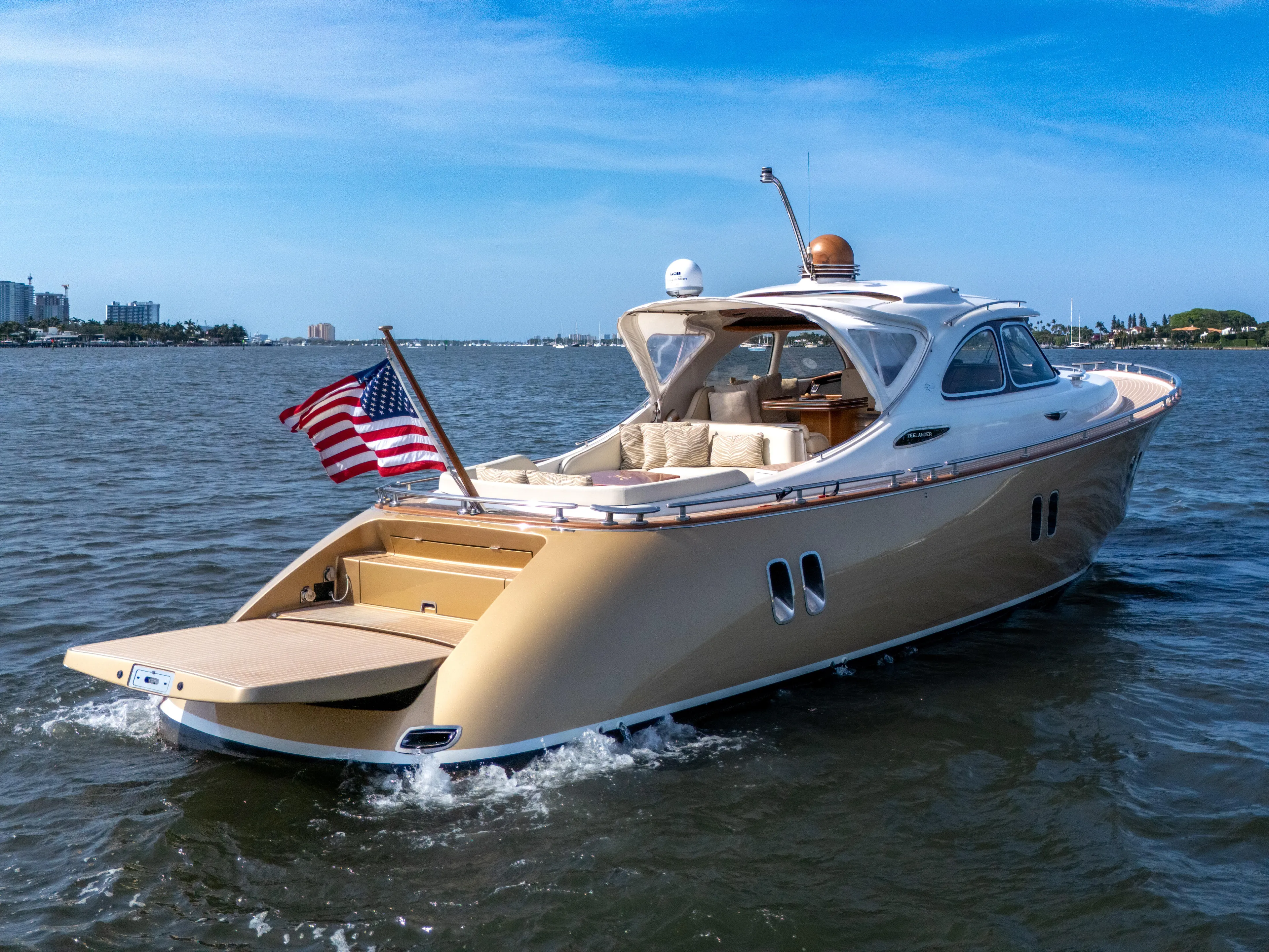 Mississippi Queen Yacht Photos Pics Luxurious 2012 Zeelander 44 yacht cruising on open water with American flag.