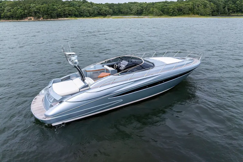 Badleship Yacht Photos Pics 2015 Riva Rivale luxury yacht cruising on a serene lake with lush green shoreline.