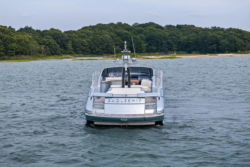 Badleship Yacht Photos Pics Luxury 2015 Riva Rivale yacht on serene water near lush green shoreline.