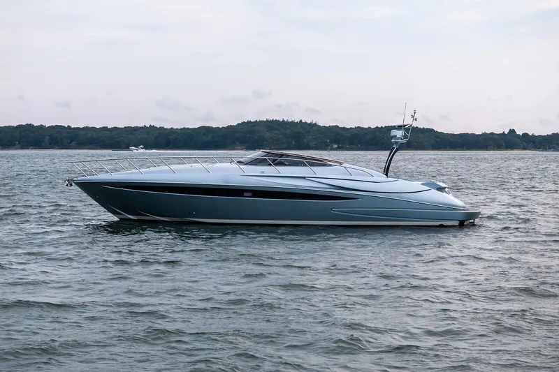 Badleship Yacht Photos Pics 2015 Riva Rivale yacht on calm water, sleek design, side view.