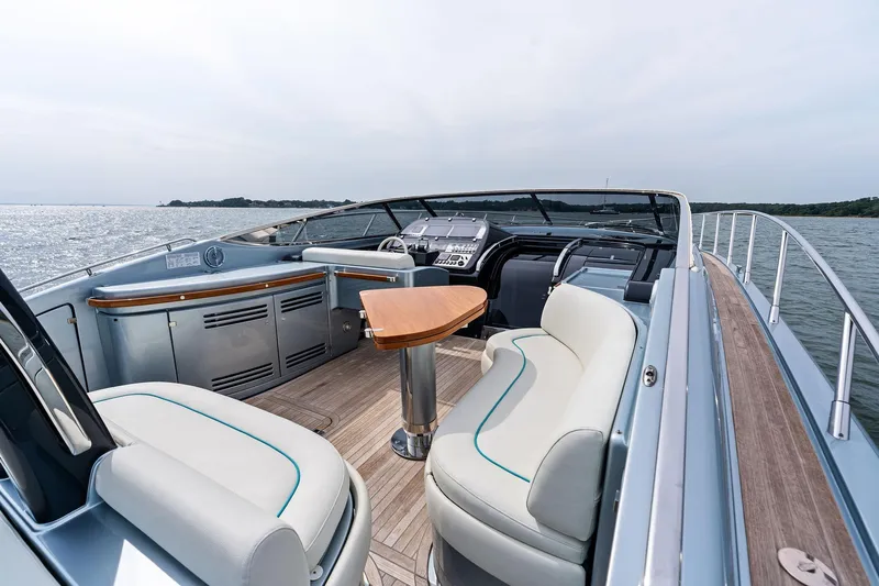 Badleship Yacht Photos Pics Luxurious 2015 Riva Rivale yacht interior with elegant seating and wooden accents on open water.
