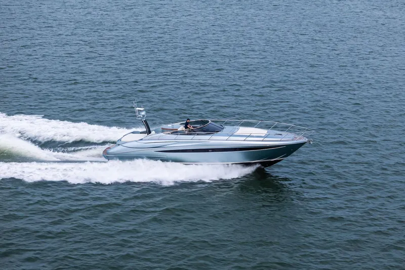 Badleship Yacht Photos Pics 2015 Riva Rivale yacht cruising swiftly on open water.