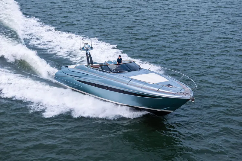 Badleship Yacht Photos Pics 2015 Riva Rivale yacht cruising on open water, showcasing sleek design and luxury.