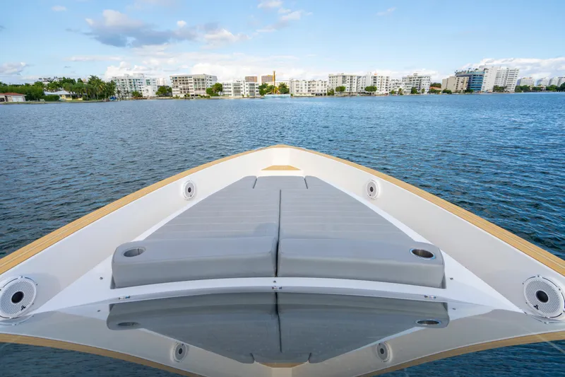  Yacht Photos Pics Pardo Yachts 38 (2021) bow view with sunbed, overlooking coastal skyline.