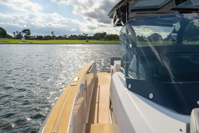  Yacht Photos Pics 2021 Pardo Yachts 38 cruising on a sunny day, with scenic water and greenery.