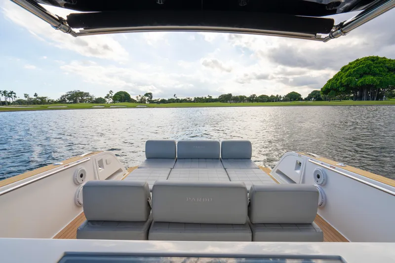  Yacht Photos Pics 2021 Pardo Yachts 38 with luxurious seating, overlooking serene water and lush greenery.