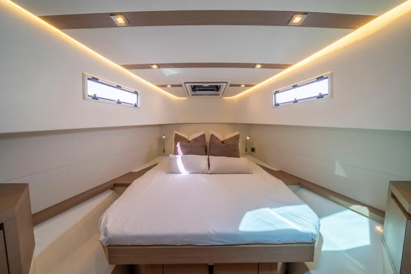  Yacht Photos Pics Luxurious cabin interior of 2021 Pardo Yachts 38 with modern lighting and cozy bedding.