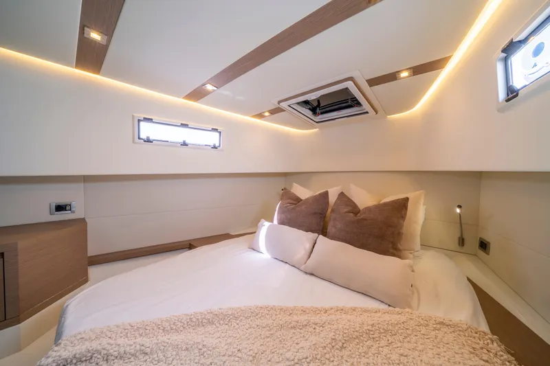  Yacht Photos Pics Luxurious cabin interior of 2021 Pardo Yachts 38, featuring cozy bedding and modern lighting.