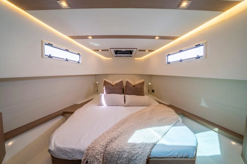  Yacht Photos Pics Luxurious cabin interior of 2021 Pardo Yachts 38 with cozy bedding and ambient lighting.