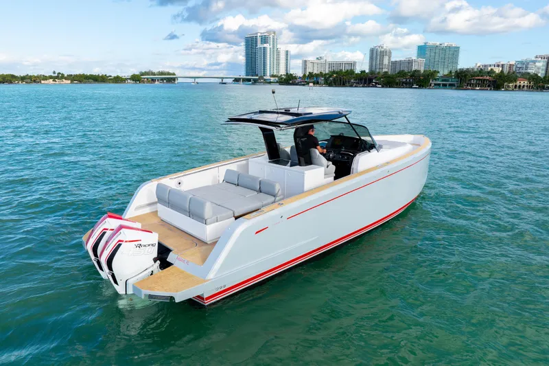  Yacht Photos Pics Pardo Yachts 38, 2021 model, cruising on clear blue waters near a cityscape.