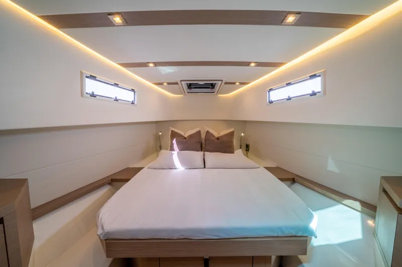  Yacht Photos Pics Luxurious cabin interior of 2021 Pardo Yachts 38, featuring a cozy bed and modern lighting.