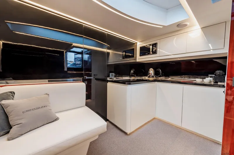 Vespro 55 Yacht Photos Pics Luxurious interior of 2026 Centouno Navi VESPRO yacht with modern kitchen and seating area.